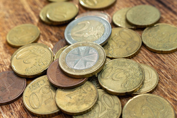 coins old rusty brass euro pile pack heap stack on a wooden background finance economy investment savings concept mock up selective focus close up