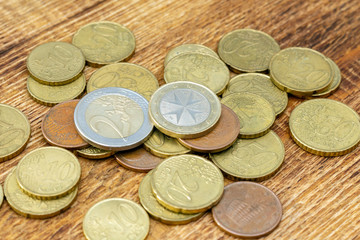 coins old rusty brass euro pile pack heap stack on a wooden background finance economy investment savings concept mock up selective focus close up