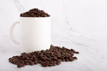 White Cup of coffee , Coffee beans in coffee cup on white marble background