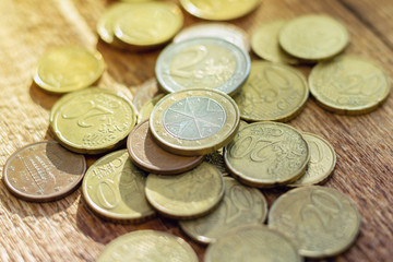 coins old rusty brass euro pile pack heap stack on a wooden background finance economy investment savings concept mock up selective focus close up