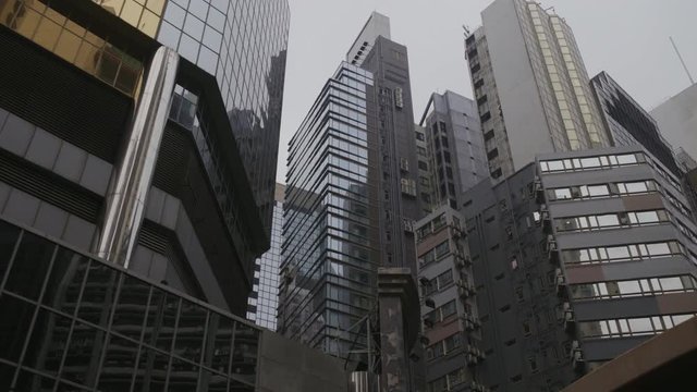 High rise buildings in Causeway Bay - smooth moving low angle shot on a cloudy afternoon