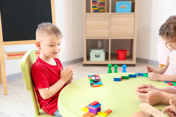 Cute little children playing in kindergarten
