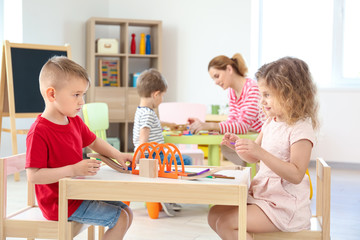 Cute little children playing in kindergarten