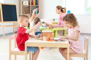 Cute little children playing in kindergarten