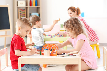 Cute little children playing in kindergarten