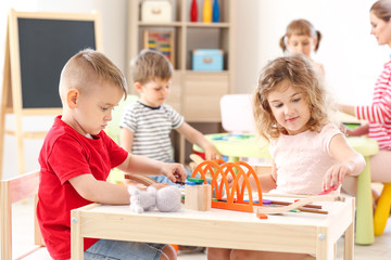 Cute little children playing in kindergarten