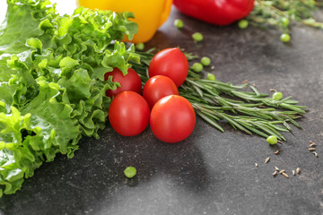 Fresh herbs with vegetables on grey background