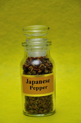 A jar filled with Japanese salt on a yellow background