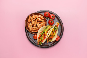 Plate with tasty fresh tacos on color background