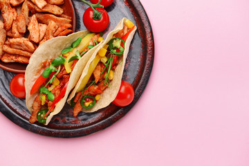 Plate with tasty fresh tacos on color background