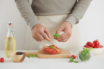 Halved juicy cherry tomatoes with fresh parsley, spices and spring onion. Home made food.