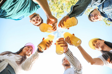 Happy friends on picnic in park, bottom view