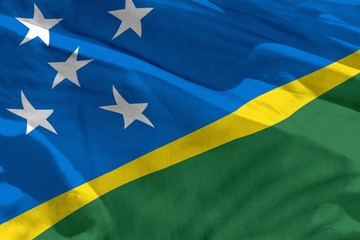 Waving Solomon Islands flag for using as texture or background, the flag is fluttering on the wind
