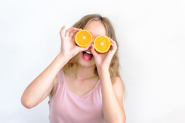 Pretty charming joyful attractive cheerful funny comic positive girl having two pieces of orange, closing two eyes, isolated on white background with copy space for