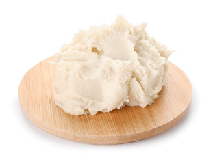 Board with shea butter on white background