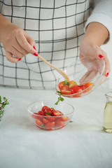 Halved juicy cherry tomatoes with fresh parsley, spices and spring onion. Home made food.