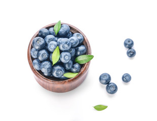 Bowl with ripe blueberry on white background