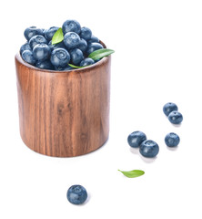 Container with ripe blueberry on white background
