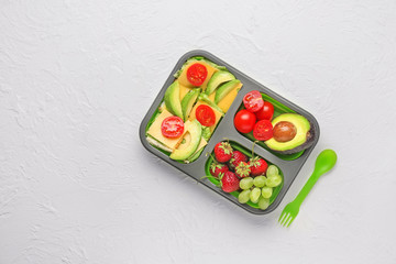 School lunch box with tasty food on white background