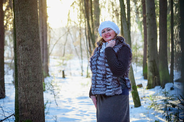 Plump woman in a nice winter forest