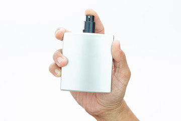perfume spray bottle in man hand on white background