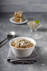 Buckwheat and quinoa porridge served with mushrooms in white vegan sauce. Healthy vegetarian food concept.