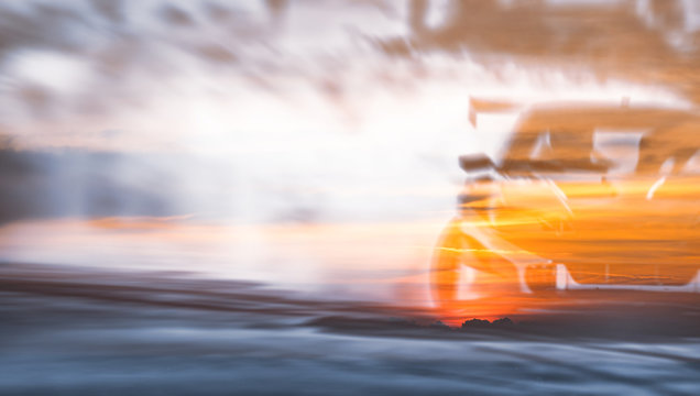 Double exposure sunset with car drifting, Blurred of image diffusion race drift car with lots of smoke from burning tires