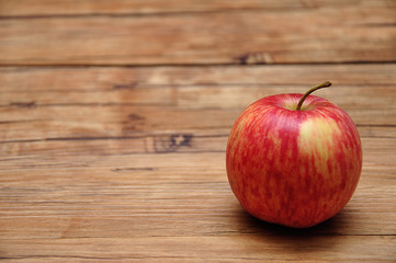 A red apple on a wooden background