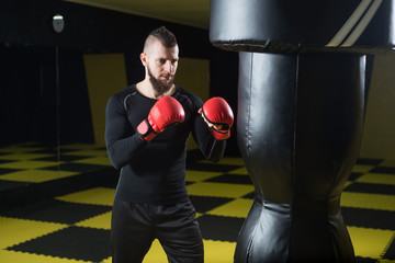 A boxer punching a bag in the gym