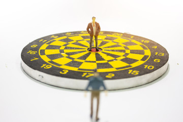 miniature businessman on target. business competition concept.