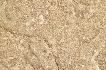 Background of natural stone wall texture rough rock surface.  Natural Stone pattern and Stone texture. surface of the Seamless rock texture background closeup with brown tint 