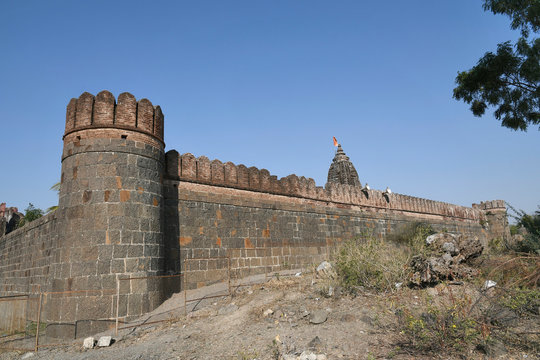 Stone masonry wall with Cylindrical watch towers at intervals surrounding entire village of  Vitthal Temple, Palashi, Parner, Ahmednagar