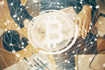 Cryptocurrency hologram over woman's hands writing background. Concept of blockchain. Double exposure