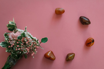 Flower bouquet with stone to circle on pink background from top. Can be used for wedding, mothers day, valentine