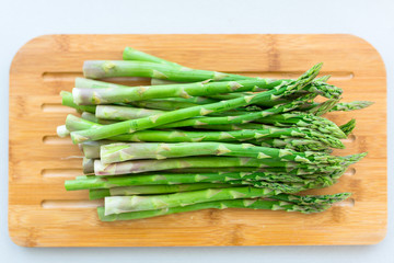Asparagus on a cutting board in the kitchen