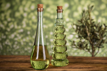 Olive tree and bottles with oil, olives on a wood table