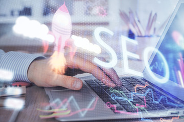 Double exposure of seo icon with man working on computer on background. Concept of search engine...
