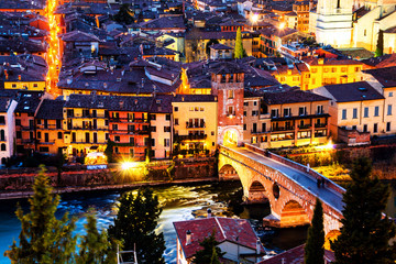 Fototapeta na wymiar Aerial view of the old town Verona, Italy. Illuminated bridge with other landmarks