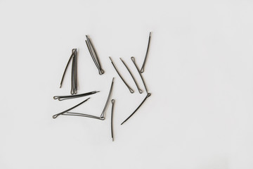 black metal hairpins roll on white background