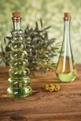 Olive oil, olive tree and green olives, bottles of olive oil