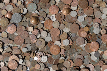 Old vintage fake coins background for sale to tourists in the Indian market on the street in Rishikesh, India. Close up