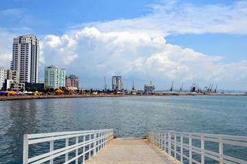 Naklejka premium Embankment at Durres city. Waterfront promenade, boulevard of Durres with amusement park, bars, restaurants, hotels and residences. View from the Adrriatic Sea