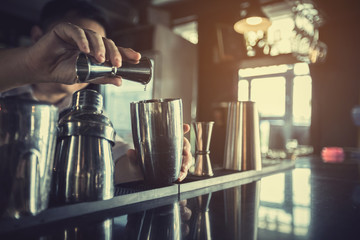 Bartenders mix drinks and serve them to customers