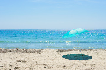 Fototapeta na wymiar Sun umbrella on the sandy beach.