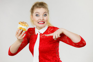 Skeptical woman holding choux puff