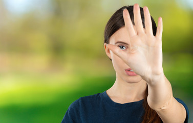 Young woman with disgusted expression repulsing something. Disgust concept