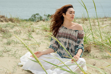 Woman with long hair meditates on nature
