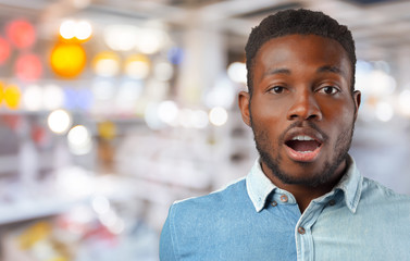 Fototapeta premium Afro american man desperate in shock. Black businessman in full despair