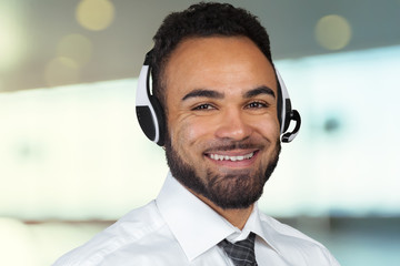 Call center operator man with headsets working