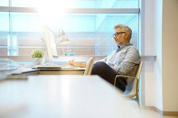 Smart casual businessman working in contemporary office